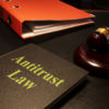 Antitrust law is shown on the conceptual photo using the text