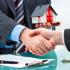 Estate agent shaking hands with customer after contract signature