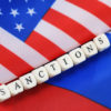 russian usa flag sanctions wooden letters on them