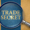 Trade Secret through Lens on Old Paper with Dark Blue Vertical Line Background. 3D Render.