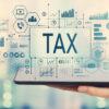Tax with man holding a tablet computer